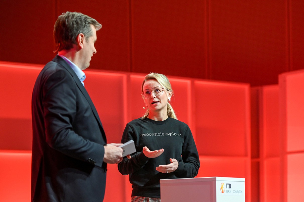 Two speakers discussing on stage. 