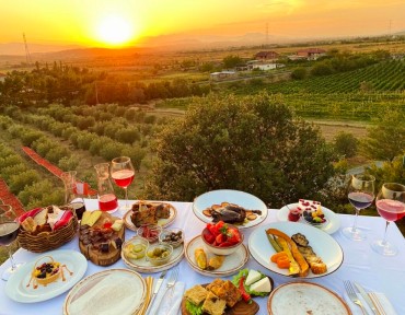 laid table, sunset in the countryside in the background)