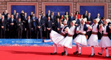 State representatives in front of the respective flags, Albanian dancers in the foreground.