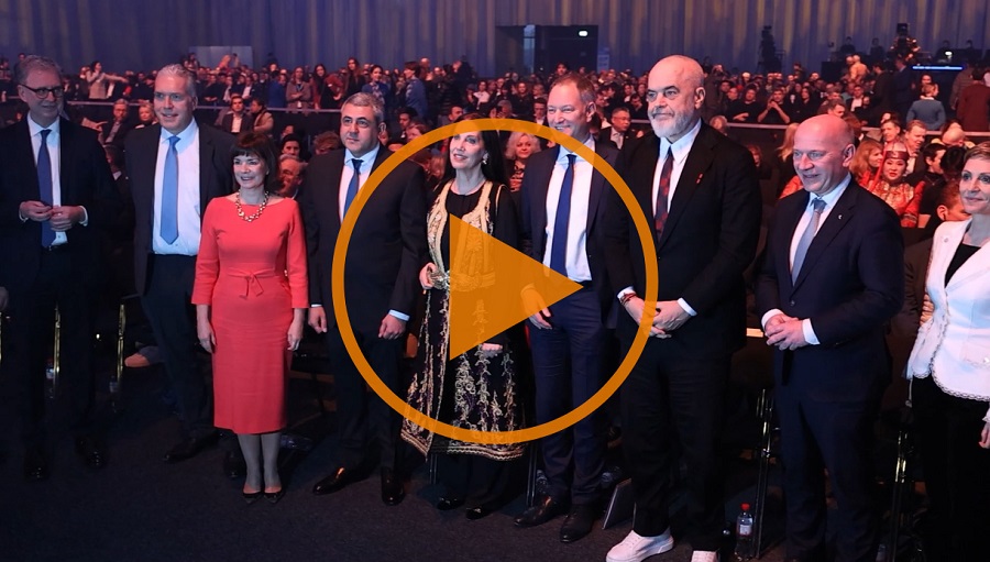 A group of elegantly dressed people at the ITB 2025 opening ceremony, surrounded by an audience in a festive hall.